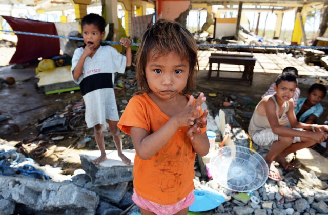 children affected by super typhoon haiyan stand inside a destroyed school building in the town of hernani eastern samar province in the central philippines on november 18 2013 over a week after the storm devastated the area photo afp children affected by super typhoon haiyan stand inside a destroyed school building in the town of hernani eastern samar province in the central philippines on november 18 2013 over a week after the storm devastated the area photo afp