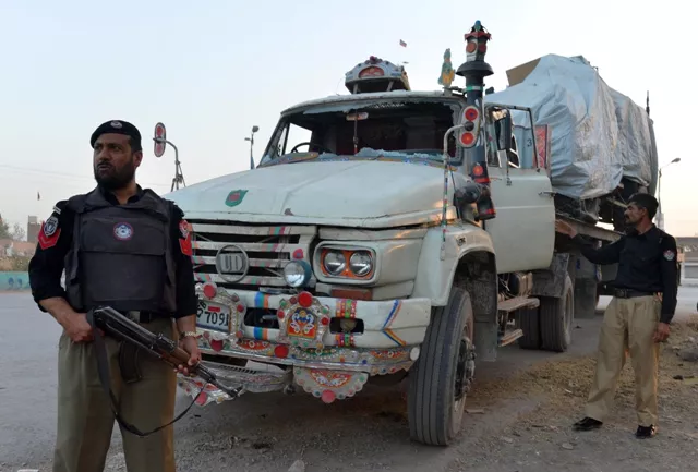 policemen stand guard beside a truck carrying a nato forces vehicle after an attack by gunmen photo afp file policemen stand guard beside a truck carrying a nato forces vehicle after an attack by gunmen photo afp file