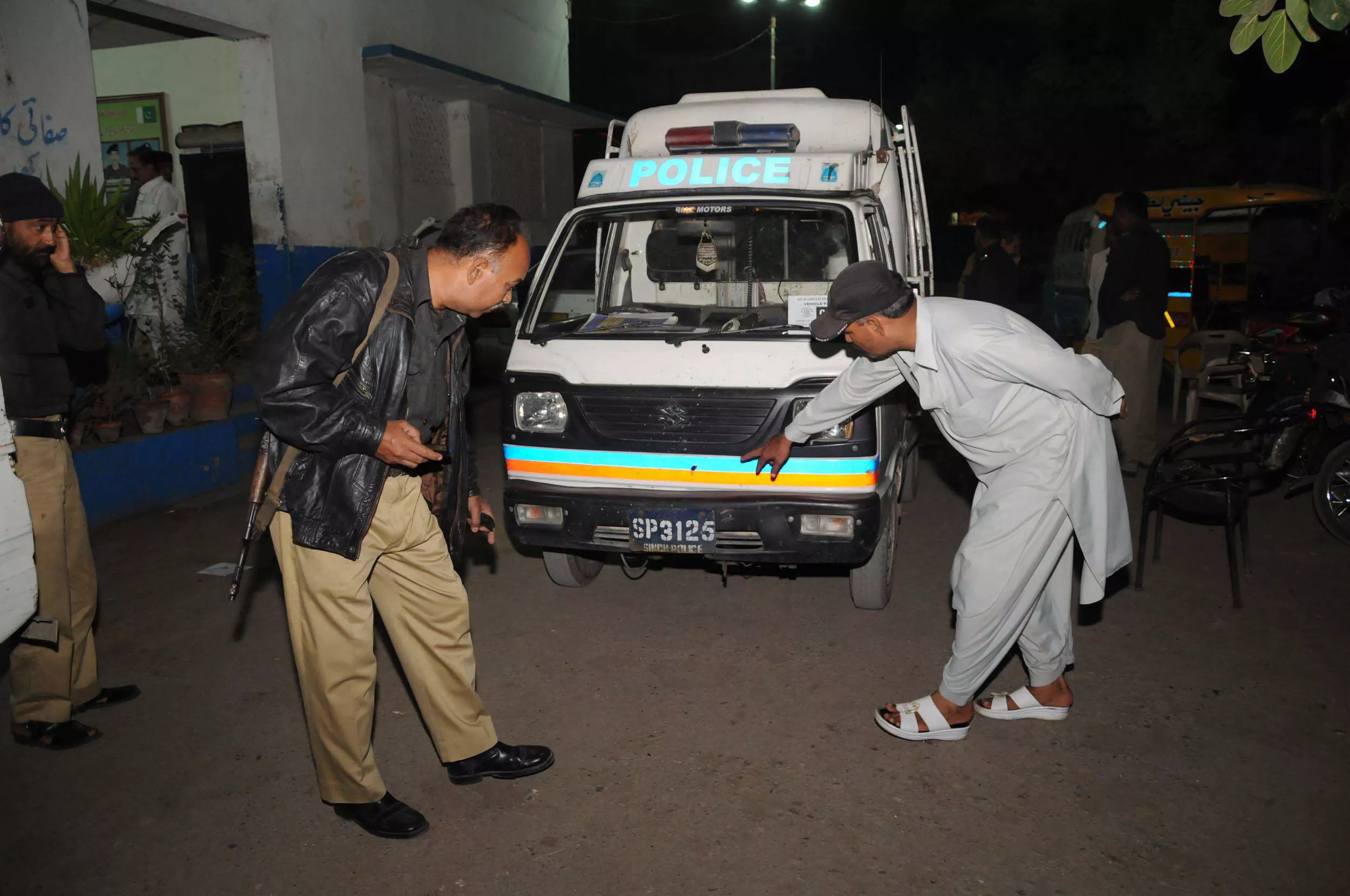 police officials inspect a police van which was targeted in karachi on monday photo mohammad noman express police officials inspect a police van which was targeted in karachi on monday photo mohammad noman express