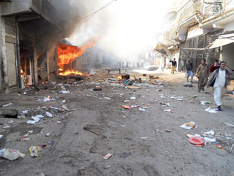 flames rise from shops torched during clashes in kohat photo online