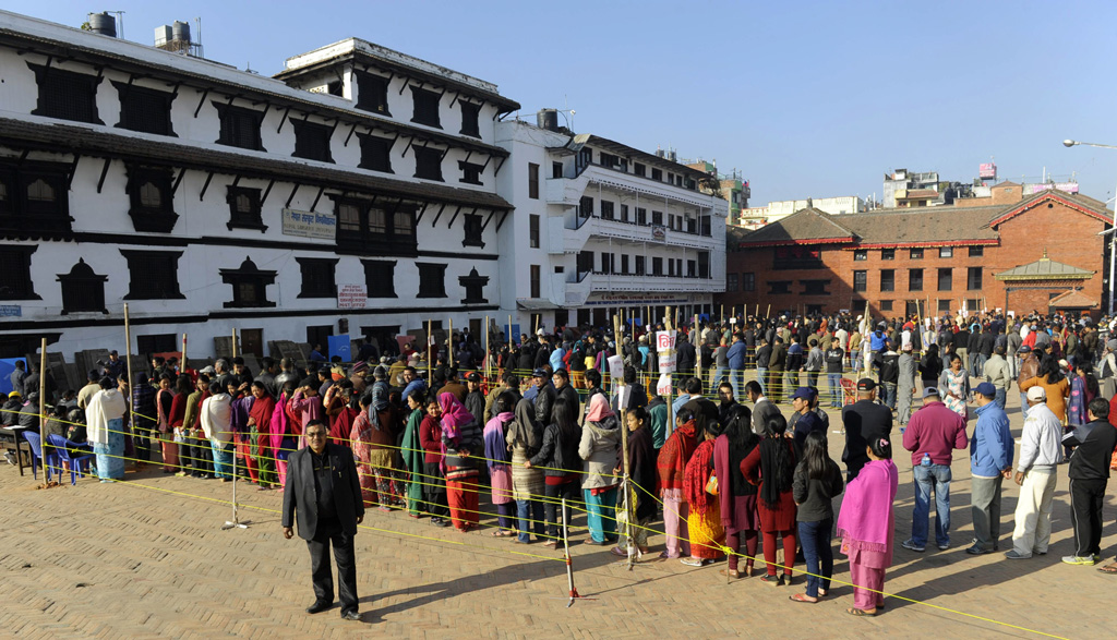 nepalese voters queue to cast their ballots at a polling station in kathmandu on november 19 2013 polling stations in nepal opened for elections that will be crucial in completing a peace process stalled for several years since the end of a decade long civil war photo afp