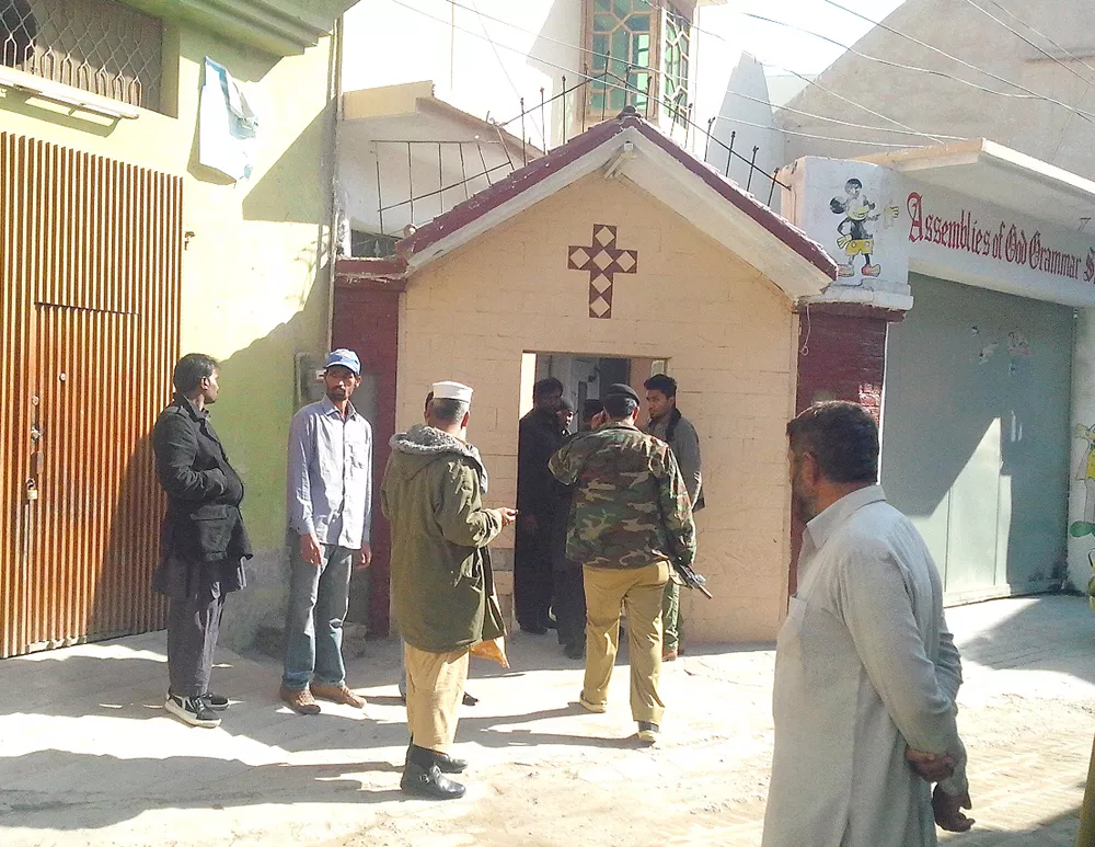 police officials inspect the site where their fellow constable was gunned down while on duty guarding the church in pishtakhara photo iqbal haider express police officials inspect the site where their fellow constable was gunned down while on duty guarding the church in pishtakhara photo iqbal haider express
