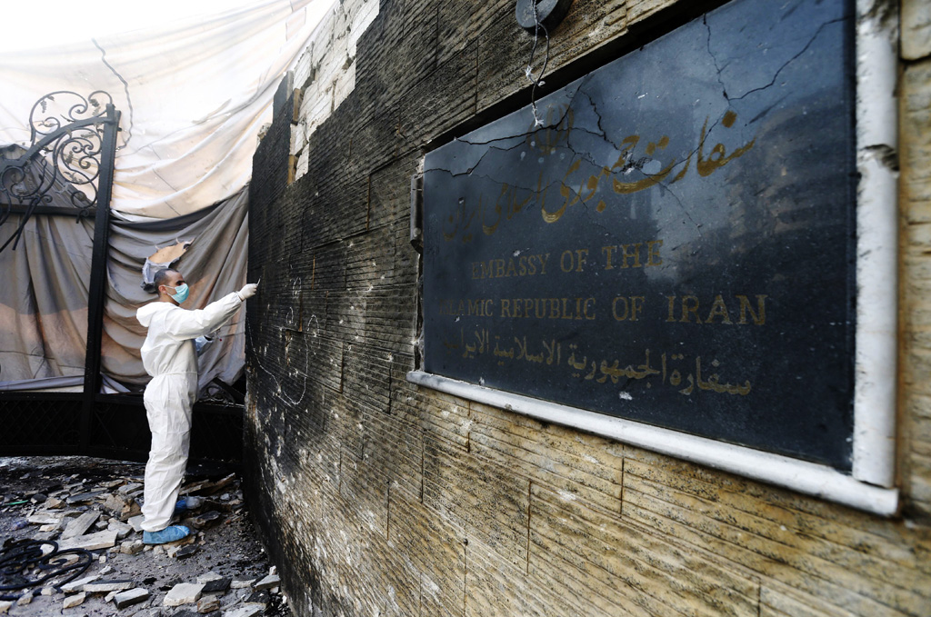 a forensic expert works on a wall of the embassy of the islamic republic of iran that was hit by a double suicide bombing in bir hassan neighbourhood in southern beirut on november 19 2013 afp