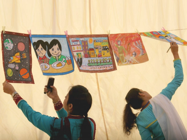 schoolchildren look at the paintings of five shortlisted candidates of different schools at a programme hosted by ngo aahung to celebrate universal children s day on wednesday photo athar khan express schoolchildren look at the paintings of five shortlisted candidates of different schools at a programme hosted by ngo aahung to celebrate universal children s day on wednesday photo athar khan express