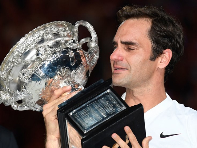 an emotional roger federer of switzerland poses with the norman brookes challenge cup after winning the 2018 australian open men s singles final photo getty