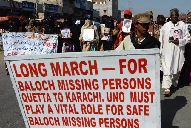 pakistani baloch families carry photographs of missing balochs at hub district as they march towards karachi from quetta photo afp pakistani baloch families carry photographs of missing balochs at hub district as they march towards karachi from quetta photo afp