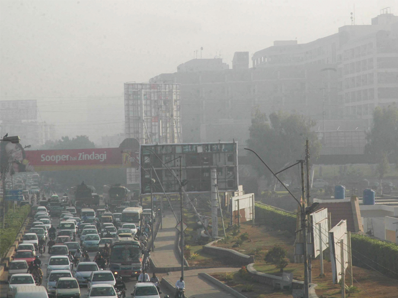 a gridlock is witnessed on sharae faisal as a blanket of fog covers buildings and limits visibility for motorists on thursday morning photo rashid ajmeri express