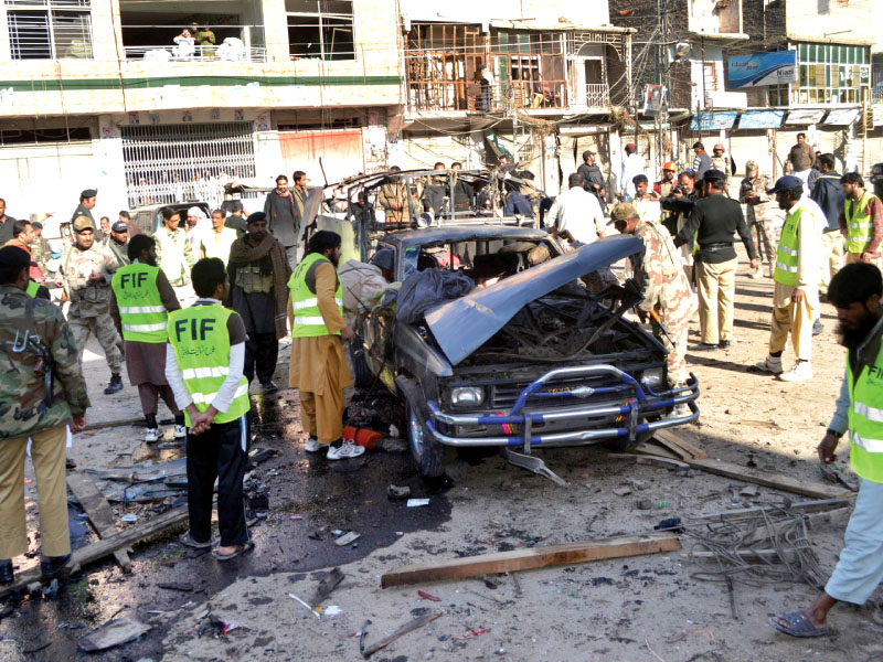 security officials examine the scene of a bomb attack in quetta that killed three people and wounded 25 others photo afp