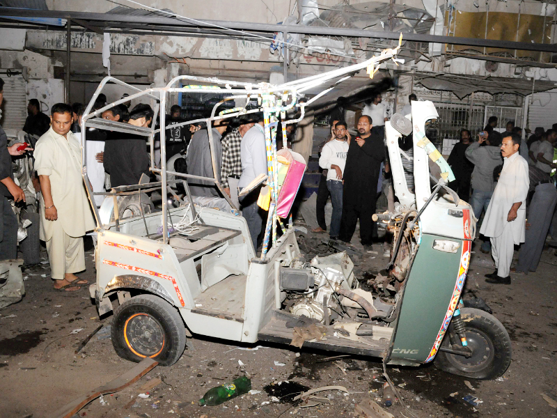 people gather at the site of twin blasts in ancholi area of karachi photo muhammad noman express