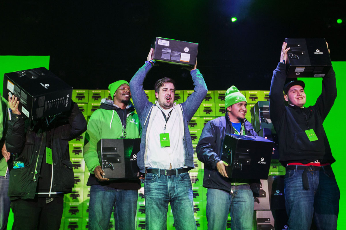 customers hold aloft their xbox one consoles purchased during a midnight launch event in new york november 22 2013 photo reuters