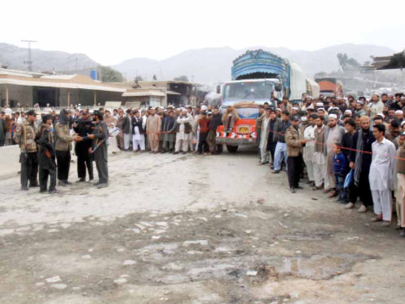 people wait at torkham border which has been closed due to security reasons and presumably the protest in peshawar against nato supply routes photo inp