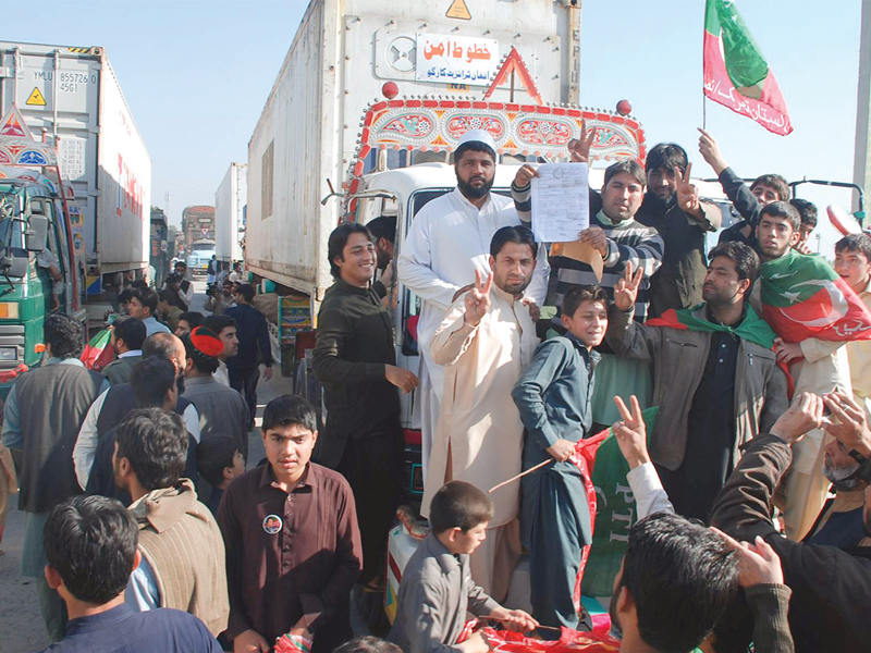 pti workers block the way of a nato container in peshawar photo express