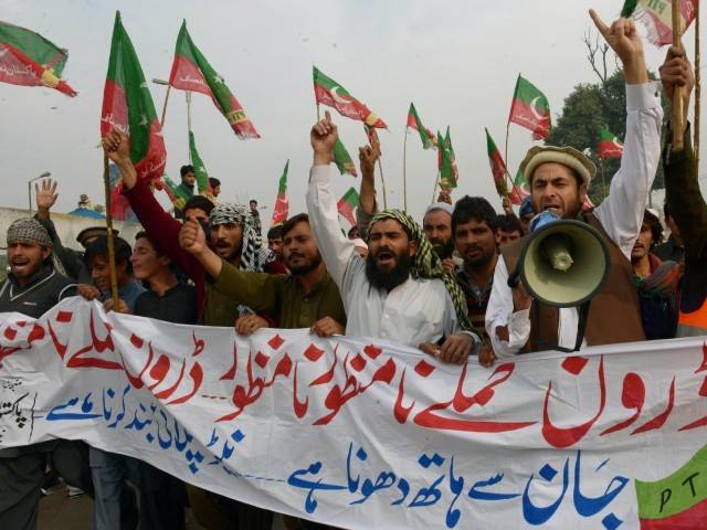 activists of pakistan tehreek e insaaf pti shout slogans as they arrive to attend a protest rally in peshawar on november 23 2013 photo afp