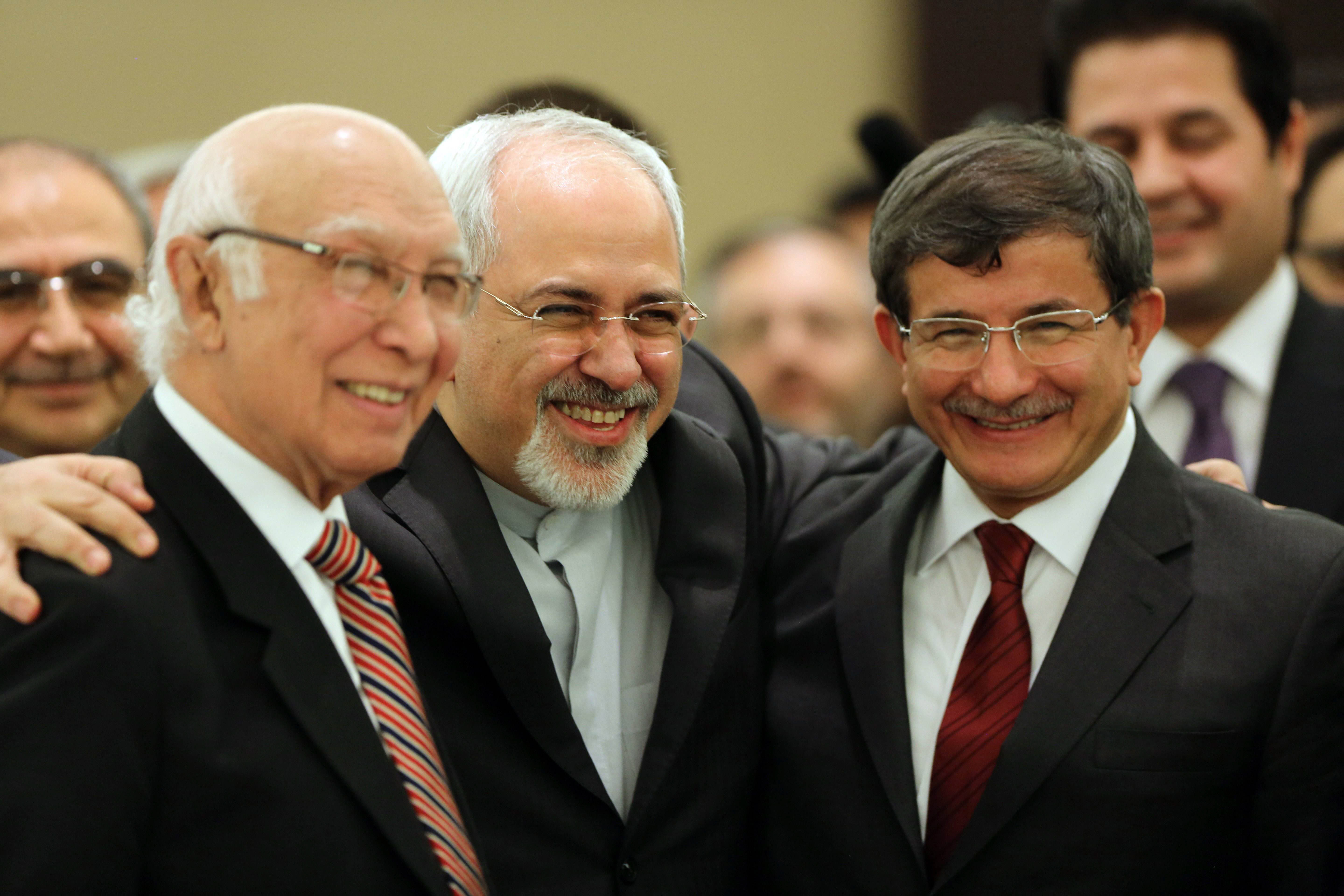 iranian foreign minister mohammad javad zarif c poses for a picture with his counterparts from pakistan sartaj aziz l and turkey ahmet davutoglu during the opening session of a two day ministerial conference of the economic cooperation organisation eco which groups 10 asian and eurasian countries in tehran on november 26 2013 photo afp