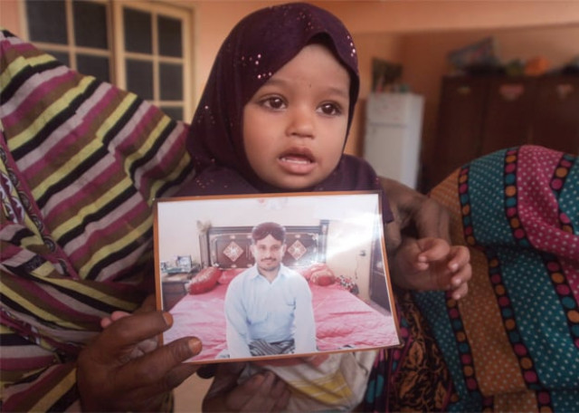 safia holds up her father 039 s picture photos athar khan express safia holds up her father 039 s picture photos athar khan express