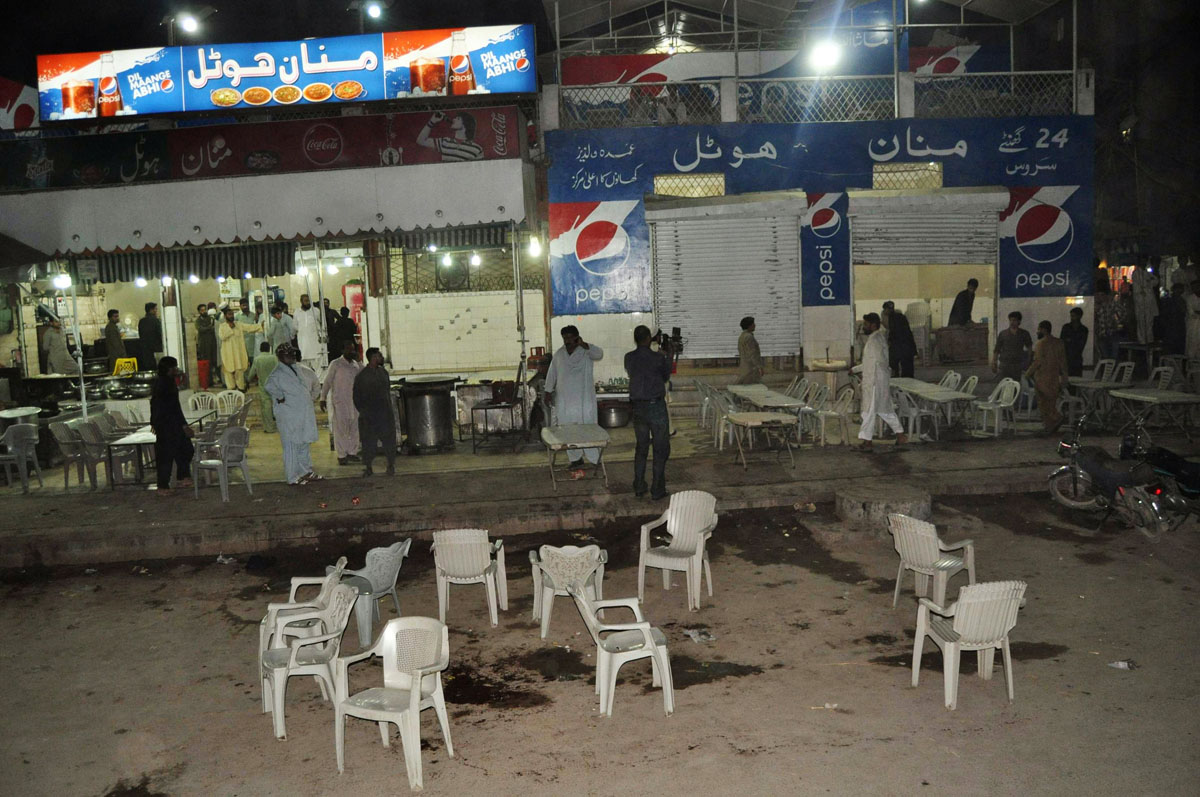 residents gather at the site of an attack by gunmen on police in the latifabad neighbourhood of hyderabad on november 26 2013 photo afp