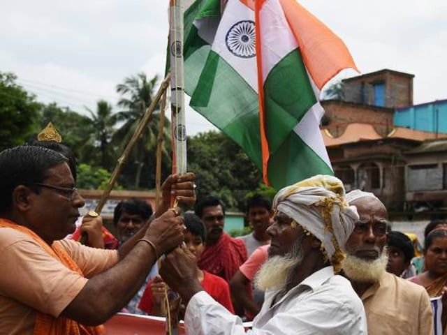 a hindu priest l and muslim mawlawi hoist the indian national flag to celebrate indian independence day in majhdia village of nadia district east of krishnanagar in west bengal on the bangladeshi border on august 18 2017 photo afp a hindu priest l and muslim mawlawi hoist the indian national flag to celebrate indian independence day in majhdia village of nadia district east of krishnanagar in west bengal on the bangladeshi border on august 18 2017 photo afp