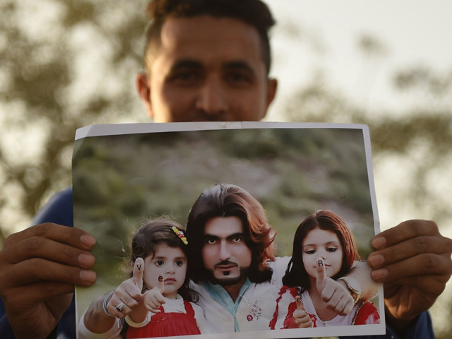 a protestor holds a photograph of naqeebullah mehsud photo afp a protestor holds a photograph of naqeebullah mehsud photo afp