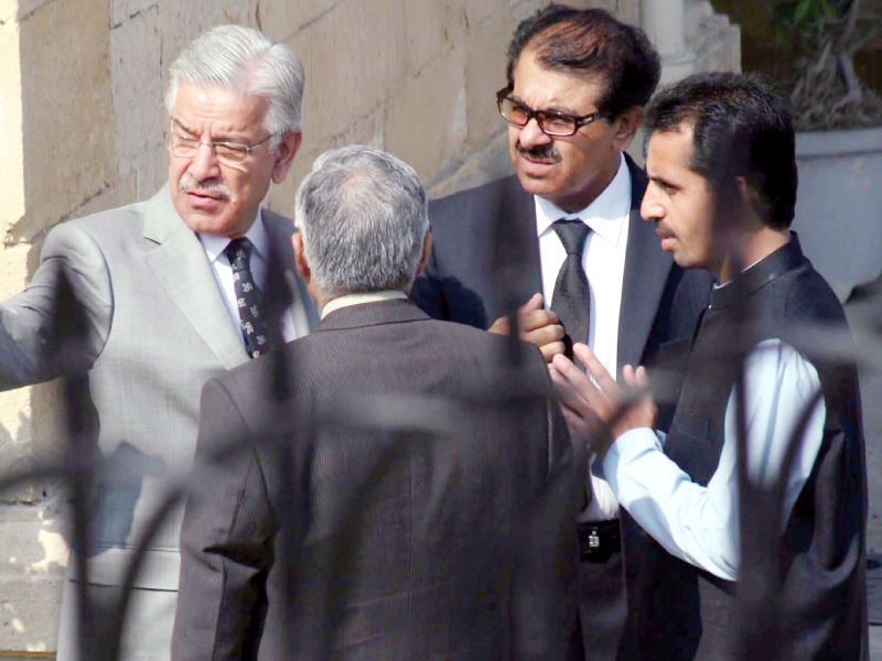 defence minister khawaja asif talking with his legal team after the hearing on missing persons in supreme court s karachi registry on thursday photo ppi