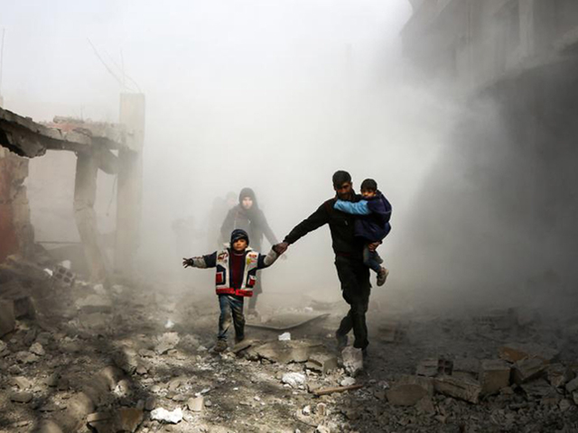 syrian civilians flee from reported regime air strikes in the rebel held town of jisreen in the besieged eastern ghouta region on the outskirts of the capital damascus on february 8 2018 photo afp