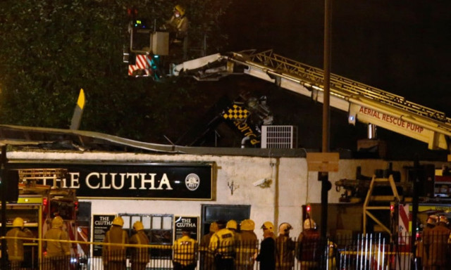 rescue workers examine the wreckage of a police helicopter which crashed onto the roof of the clutha vaults pub in glasgow scotland november 30 2013 photo reuters rescue workers examine the wreckage of a police helicopter which crashed onto the roof of the clutha vaults pub in glasgow scotland november 30 2013 photo reuters
