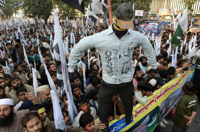 pakistani supporters of the defence of pakistan coalition shout slogans as they hold up an effigy of us president barack obama at an anti us rally in lahore on december 1 2013 photo afp pakistani supporters of the defence of pakistan coalition shout slogans as they hold up an effigy of us president barack obama at an anti us rally in lahore on december 1 2013 photo afp