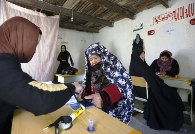 an afghan woman puts her thumb print on her voter card at a registration centre in kabul november 26 2013 photo reuters an afghan woman puts her thumb print on her voter card at a registration centre in kabul november 26 2013 photo reuters