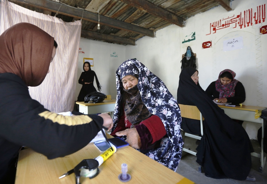 an afghan woman puts her thumb print on her voter card at a registration centre in kabul november 26 2013 photo reuters