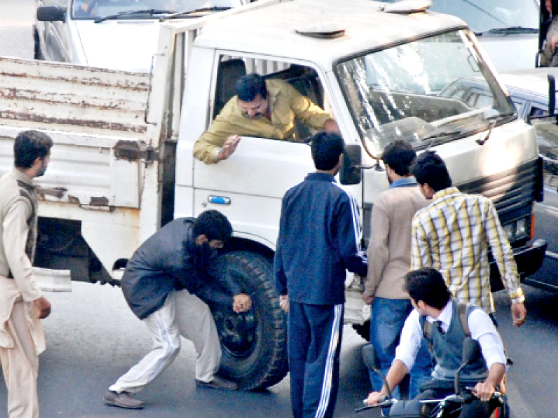 protesters attempt to disable a van using an ice pick photo shahbaz malik express