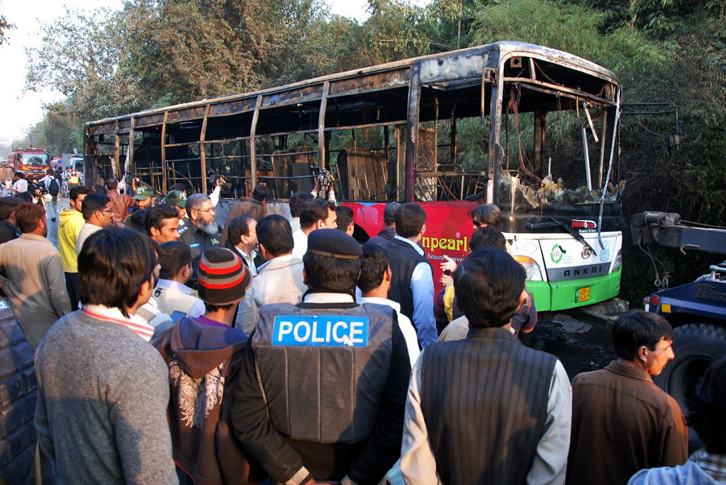 people gathered around the bus torched by the islami jamiat talaba ijt activists on monday in a protest at the punjab university s pu decision to convert a hostel for boys to one for girls photo shahbaz malik express