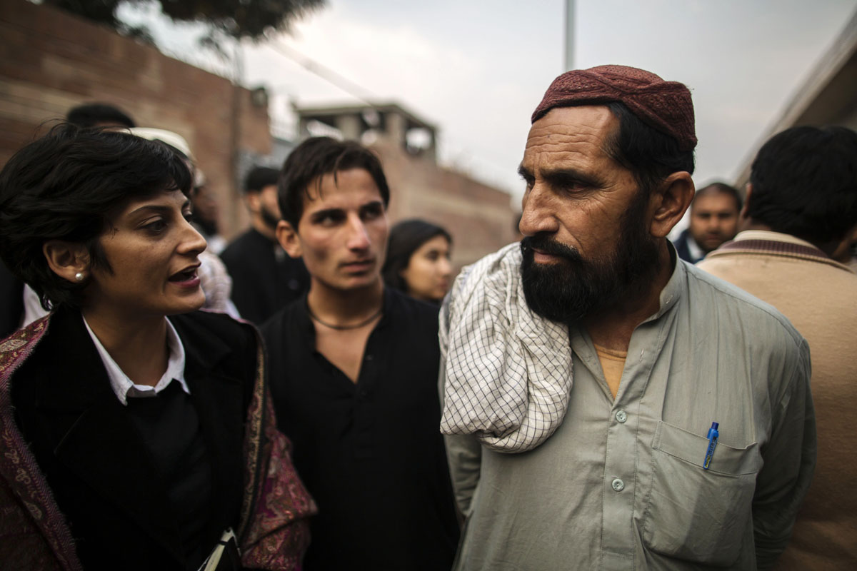 lawyer sarah belal l talks to wakeel khan r the father of one of the prisoners hamidullah outside the central jail in peshawar december 2 2013 photo reuters
