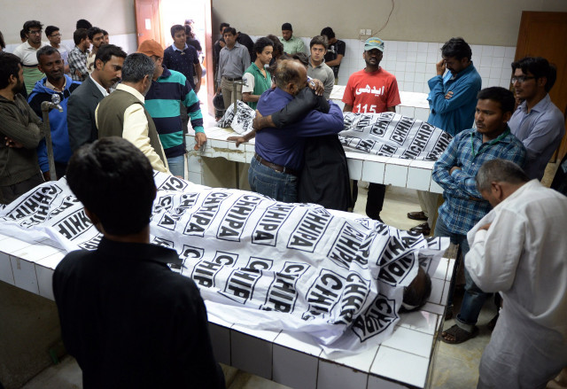 pakistani mourners gather around the bodies of the mwm leader and his guard at a mortuary photo afp pakistani mourners gather around the bodies of the mwm leader and his guard at a mortuary photo afp