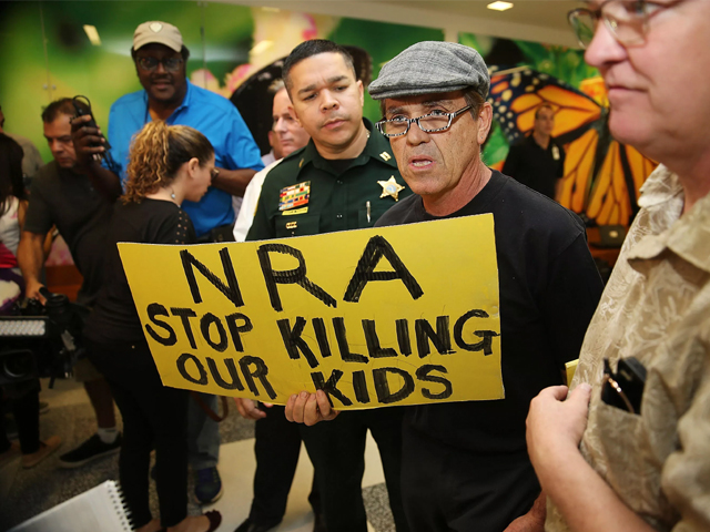 protesters against the national rifle association in florida during the first appearance in court via video link for high school shooter nikolas cruz photo afp