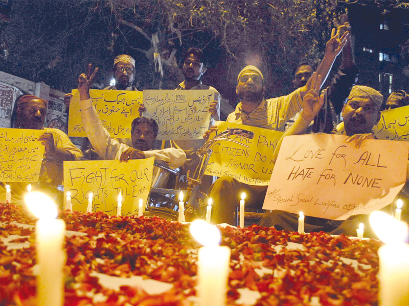 people with disabilities light candles and demand equal rights during a demonstration held at hyderabad press club on the international day for disabled persons photo ppi