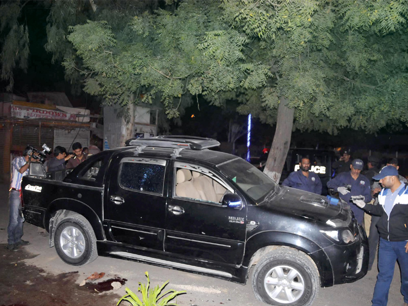 security personnel examine a vehicle which came under attack near sakhi hassan chowrangi in karachi photo mohammad noman express