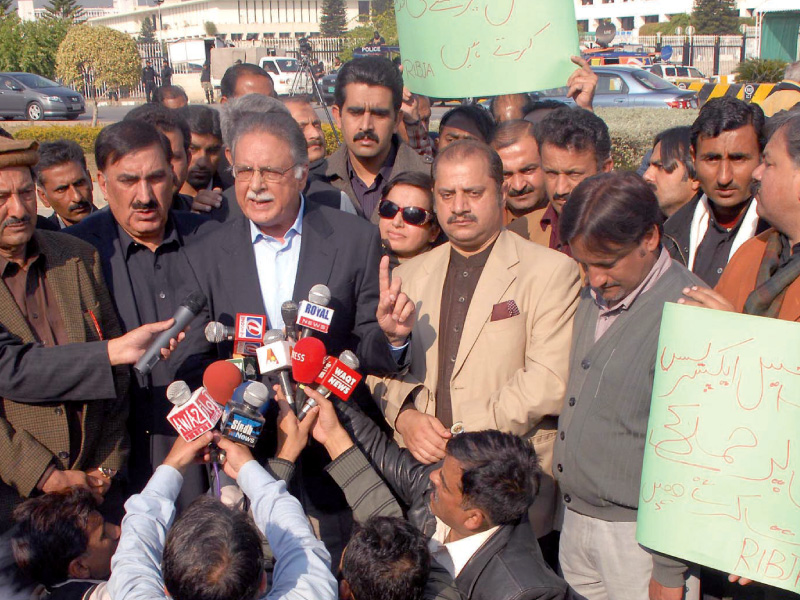 information minister pervaiz rashid talking to journalists who staged a protest outside senate against attack on the express media group s offices photo muhammad javaid express