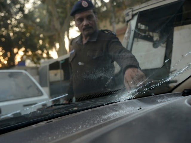 a policeman examines the vehicle in which maulana dedar ali jalbani was attacked photo afp a policeman examines the vehicle in which maulana dedar ali jalbani was attacked photo afp