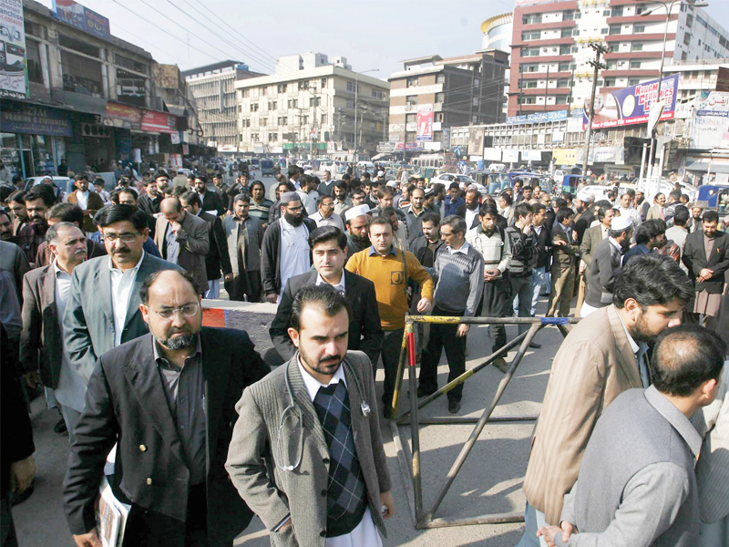 members of young doctors association protest at soe karno chowk near lady reading hospital on wednesday against kidnapping of doctors photo ppi