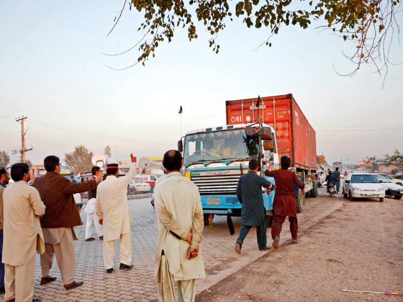 protesters stop a truck driver in a bid to block the nato supplies in peshawar on wednesday photo afp