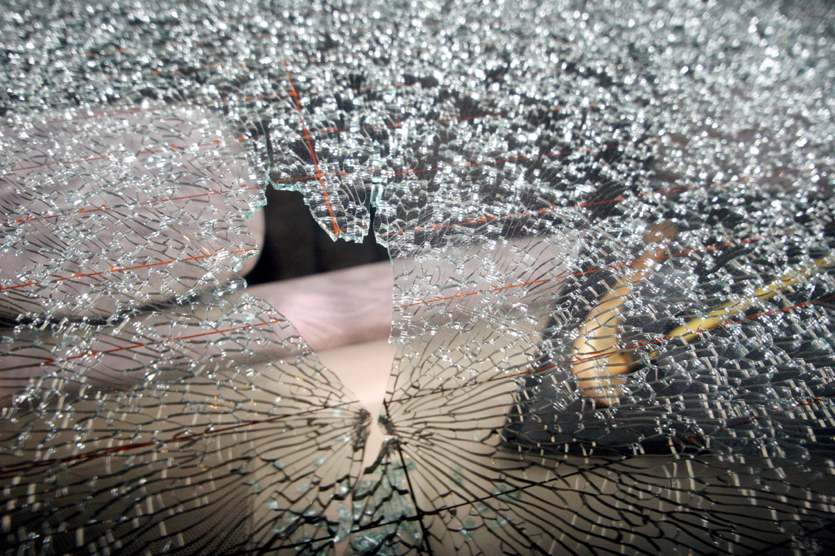 a view of shattered wind shield of a vehicle in the attack on the express media group s offices in karachi on december 2 2013 photo athar express