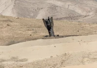 part of a missile protrudes from the ground following strikes from iran in the israeli occupied west bank photo reuters
