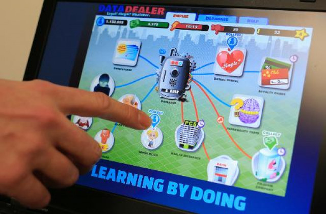 a man points out an icon in the quot data dealer quot game on a laptop screen in vienna on november 21 2013 photo afp a man points out an icon in the quot data dealer quot game on a laptop screen in vienna on november 21 2013 photo afp