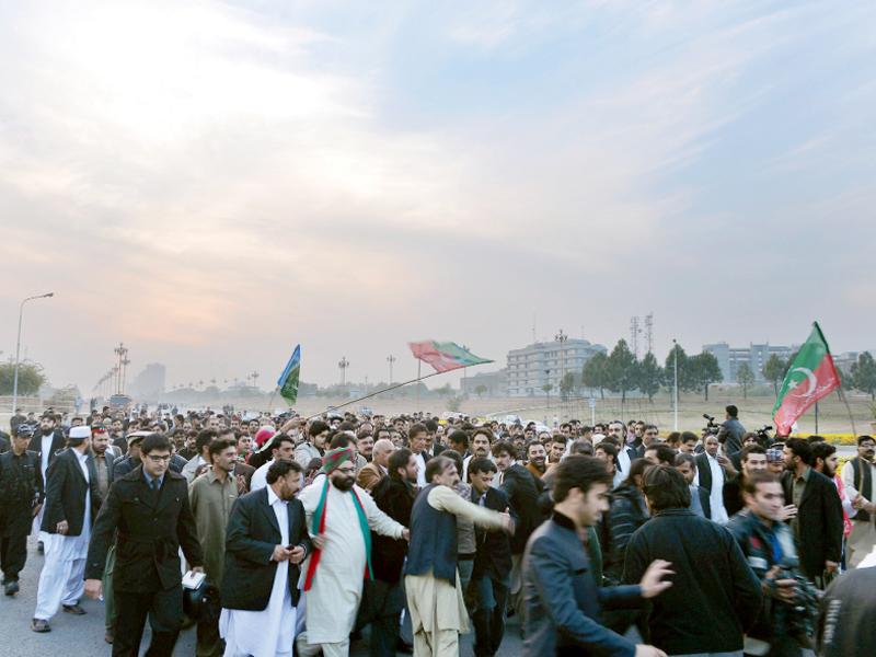 legislators and supporters of pti march toward the parliament house photo afp