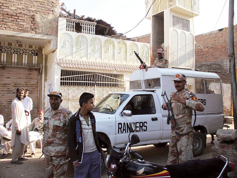 rangers personnel stand outside a house in latifabad after a huge gas explosion destroyed four houses and left 15 injured photo online