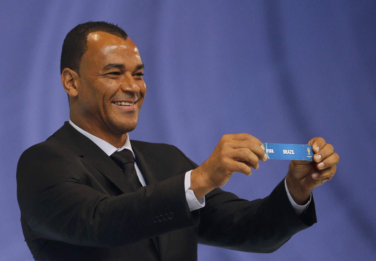 former brazilian football player cafu holds the slip showing quot brazil 039 during the draw for the 2014 world cup at the costa do sauipe resort in sao joao da mata bahia state december 6 2013 photo reuters