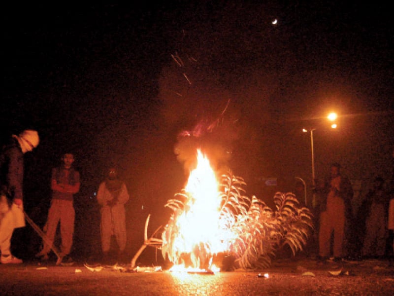 workers of the aswj burn tyres at aabpara to condemn killing of their leader in lahore photo muhammad javaid