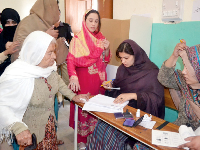 an elderly woman checks her name in the electoral list at a polling station in balochistan photo express naseem james an elderly woman checks her name in the electoral list at a polling station in balochistan photo express naseem james