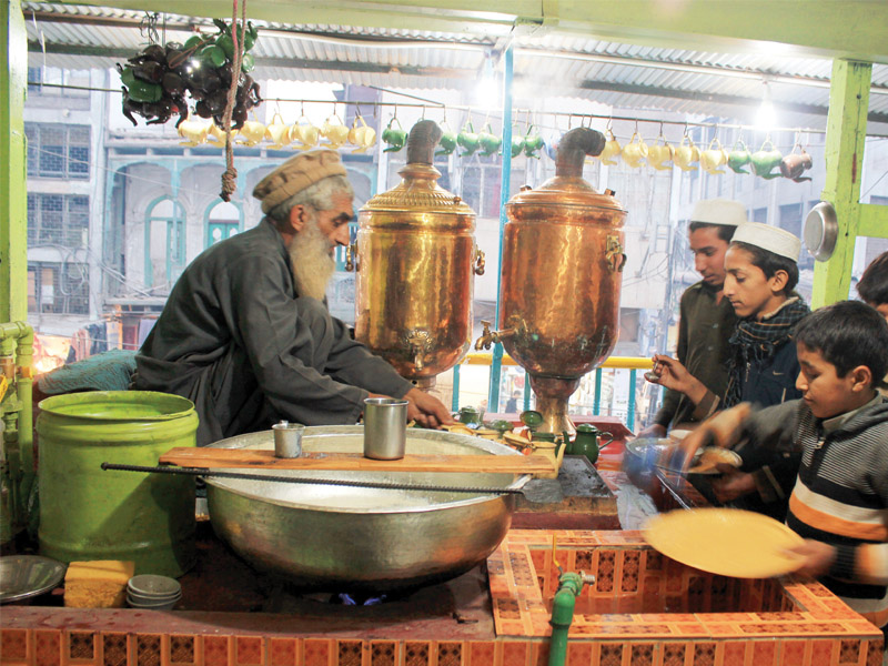 the once decrepit and fading tea shop now has whitewashed walls a fresh coat of green paint and new seating arrangements photo muhammad iqbal express