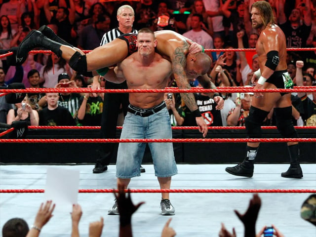 wrestler john cena picks up wrestler randy orton as wrestler triple h r looks on during the wwe monday night raw show on august 24 2009 in las vegas nevada photo getty wrestler john cena picks up wrestler randy orton as wrestler triple h r looks on during the wwe monday night raw show on august 24 2009 in las vegas nevada photo getty