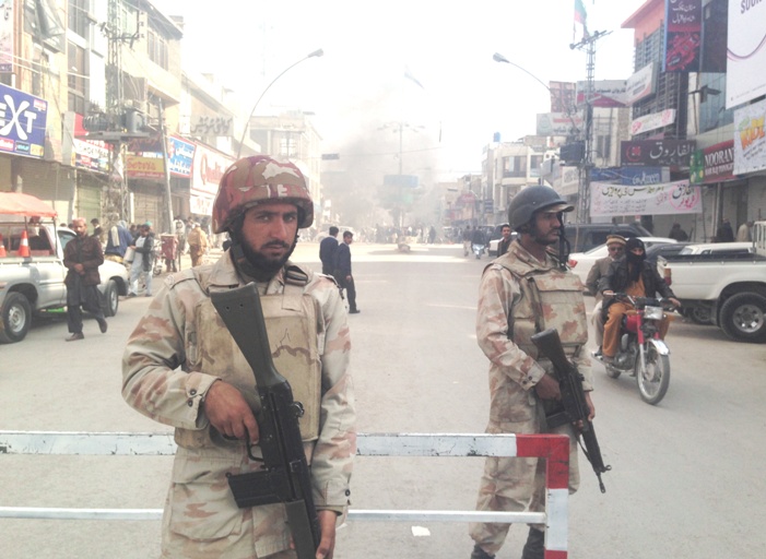 fc personnel blocking a road where protestors burnt tires in quetta photo shehzad baloch express